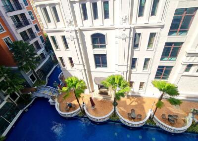 Aerial view of a building with a courtyard and pool