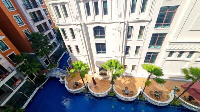 Aerial view of a building with a courtyard and pool