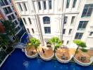 Aerial view of a building with a courtyard and pool