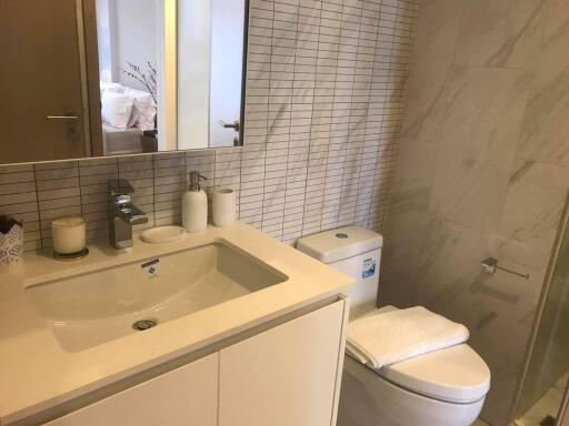 Modern bathroom with white sink, toilet, and shower