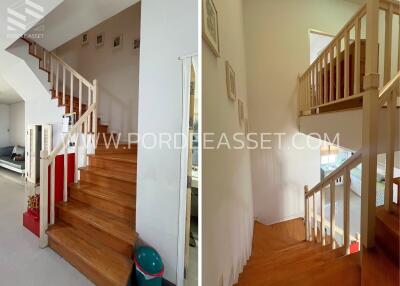 Staircase with wooden steps and white railings