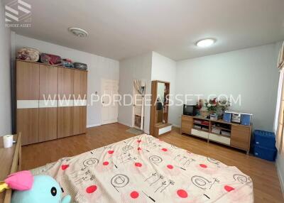 Spacious bedroom with bed, wardrobe, and entertainment area