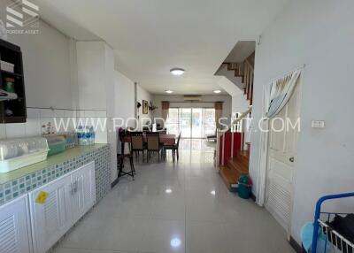 Spacious open-plan living area with dining table and staircase