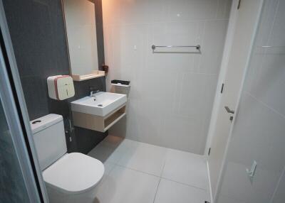 Modern bathroom with white fixtures and tiled walls