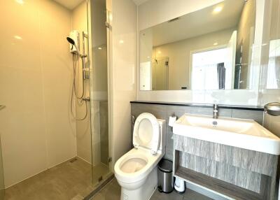 Modern bathroom with shower, toilet, and sink