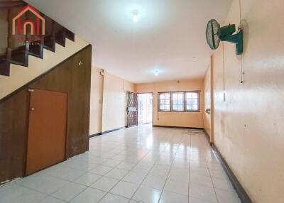 Spacious main living area with tiled flooring and stair access