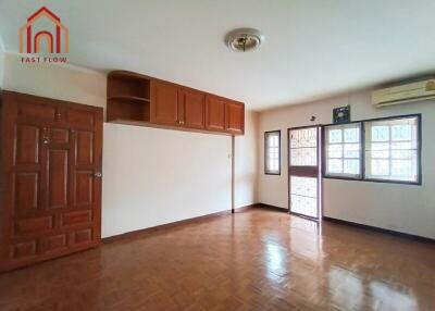 Spacious living room with wooden flooring and ample natural light