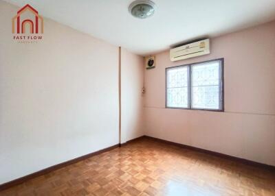 Empty bedroom with wooden floor and air conditioner