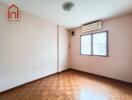 Empty bedroom with wooden floor and air conditioner