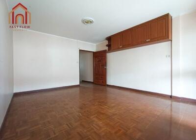 Spacious living room with wooden flooring and built-in storage