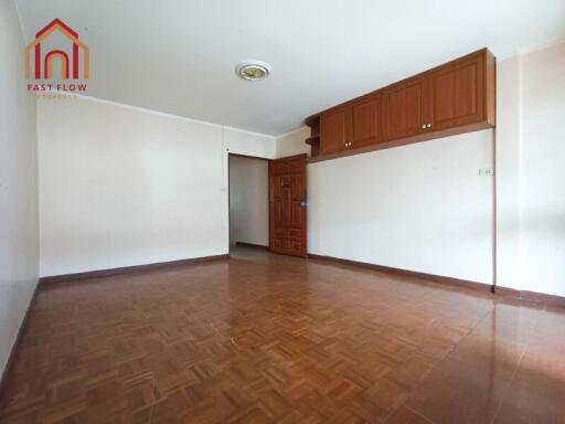 Spacious living room with wooden flooring and built-in storage