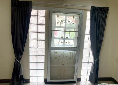 Bedroom window with curtains and security grill