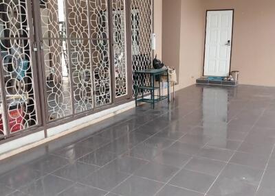 Spacious covered area with patterned grills and tiled floor