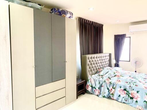 Master bedroom with bed, wardrobe, air conditioning, and natural light