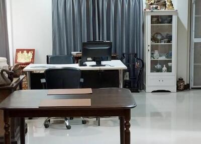 Home office with desk, chairs, and cabinet