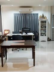 Home office with desk, chairs, and cabinet