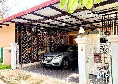 Exterior view of house with car in carport