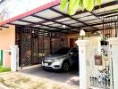 Exterior view of house with car in carport