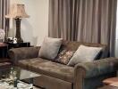 A well-furnished living room with a sofa, a glass coffee table, and various decorative items