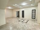 Spacious living room with tiled flooring and ceiling lights