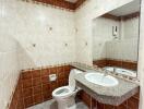 Bathroom with tiled walls and a large mirror