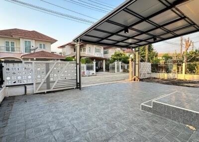 Covered outdoor carport with paved driveway