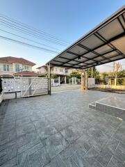 Covered outdoor carport with paved driveway