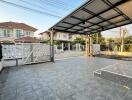 Covered outdoor carport with paved driveway