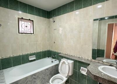 Bathroom with bathtub, toilet, sink, and tiles