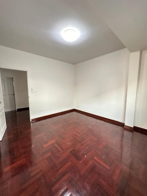 Empty bedroom with wooden flooring