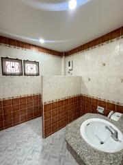 Bathroom with tiled walls and a wash basin