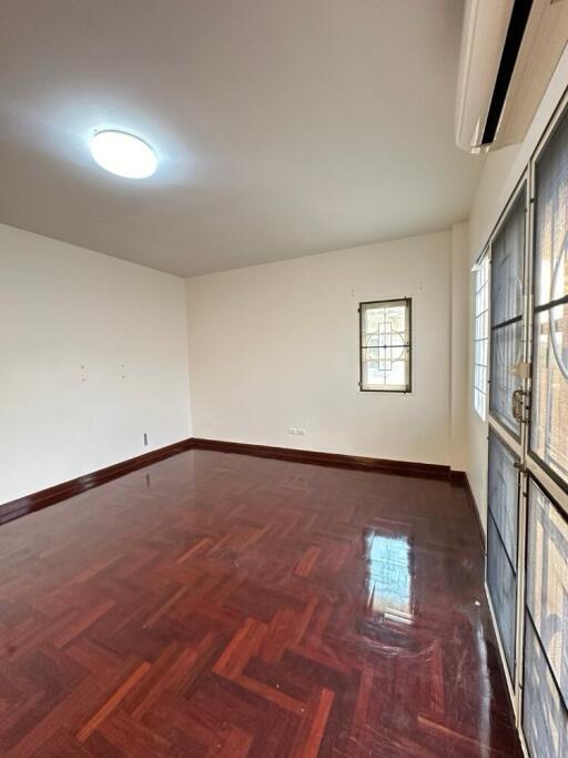 Empty living room with parquet flooring