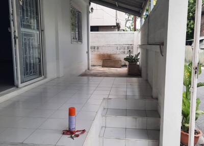 Main entrance area with tiled steps and a covered porch