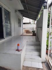 Main entrance area with tiled steps and a covered porch