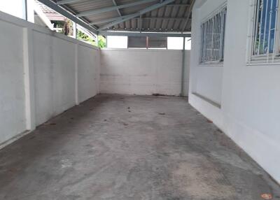 Indoor garage with concrete floor and metal roofing