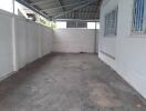 Indoor garage with concrete floor and metal roofing