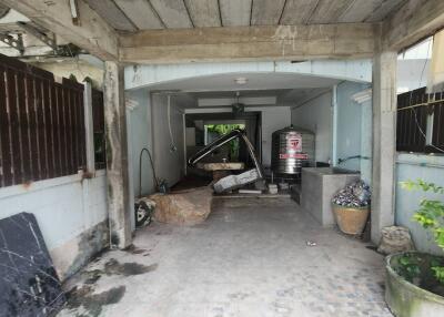 Garage area with stored items and a tiled floor