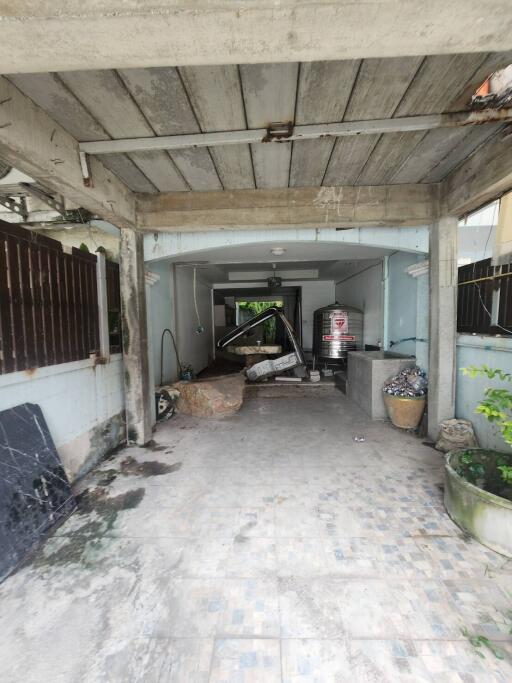 Garage area with stored items and a tiled floor