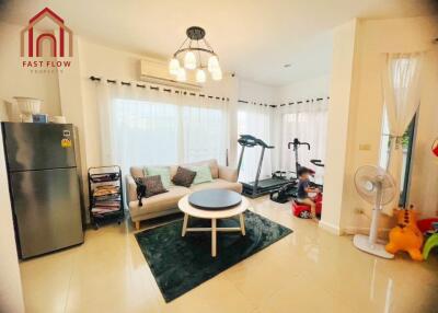 Bright and cozy living room with modern decor and exercise equipment