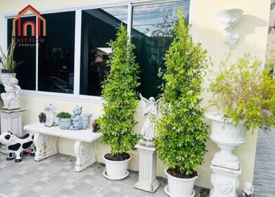 Front porch with decorative plants and ornaments