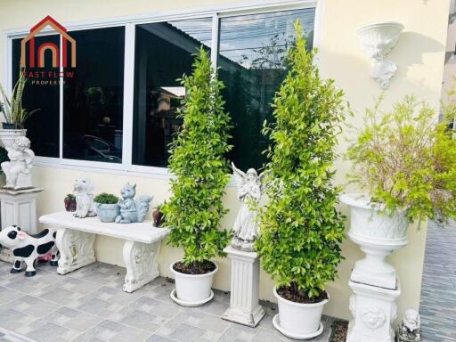 Front porch with decorative plants and ornaments