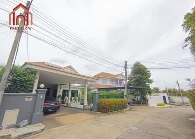 Exterior view of the house with garage and garden