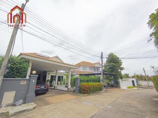 Exterior view of the house with garage and garden