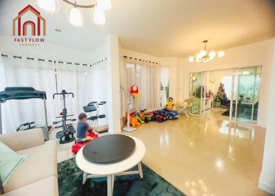 Spacious living area with exercise equipment and children