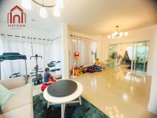 Spacious living area with exercise equipment and children