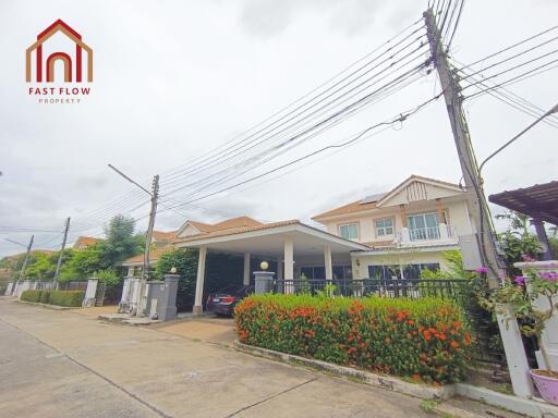 Exterior view of residential building with driveway and garden