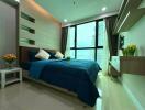 Modern bedroom with large window and blue bedding