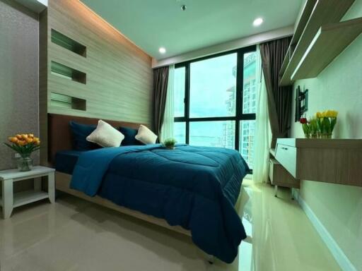 Modern bedroom with large window and blue bedding