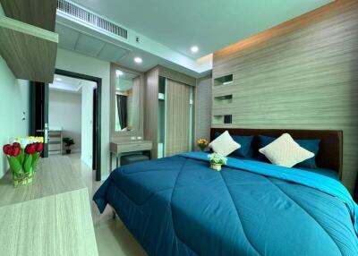 Modern bedroom with blue bedding and wooden furnishings