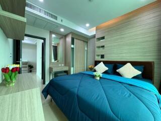 Modern bedroom with blue bedding and wooden furnishings